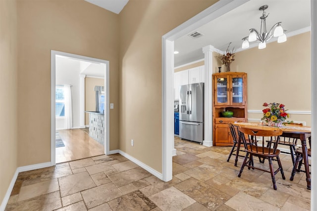 dining space featuring an inviting chandelier and ornamental molding