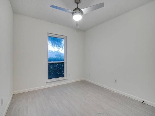 unfurnished room with baseboards, ceiling fan, and wood finished floors