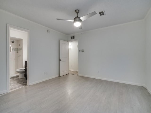 unfurnished bedroom featuring visible vents, ornamental molding, and light wood-style floors