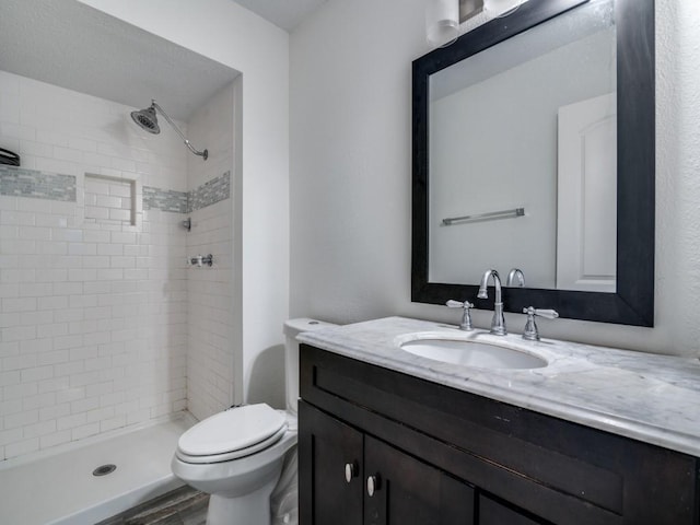 full bath with toilet, a stall shower, wood finished floors, and vanity