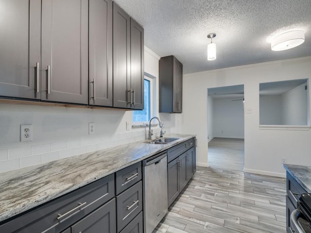 kitchen featuring a sink, a textured ceiling, light wood-style flooring, baseboards, and stainless steel dishwasher