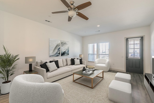 living room featuring hardwood / wood-style floors, a healthy amount of sunlight, and ceiling fan