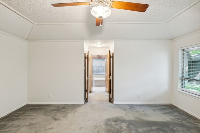 unfurnished room featuring ornamental molding, lofted ceiling, and carpet floors