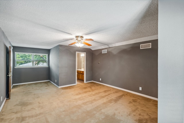 interior space with light carpet, a textured ceiling, and ceiling fan