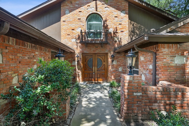 view of exterior entry with a balcony