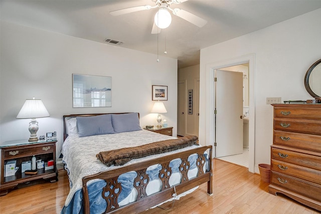 bedroom with light wood-style floors, ceiling fan, and visible vents