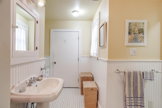 bathroom featuring a wainscoted wall and a sink