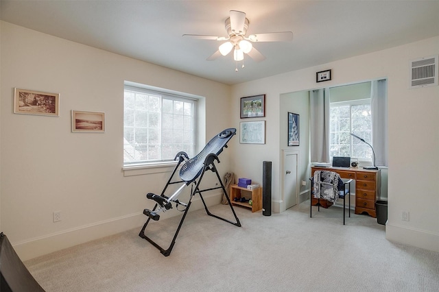 workout room featuring carpet floors, visible vents, ceiling fan, and baseboards