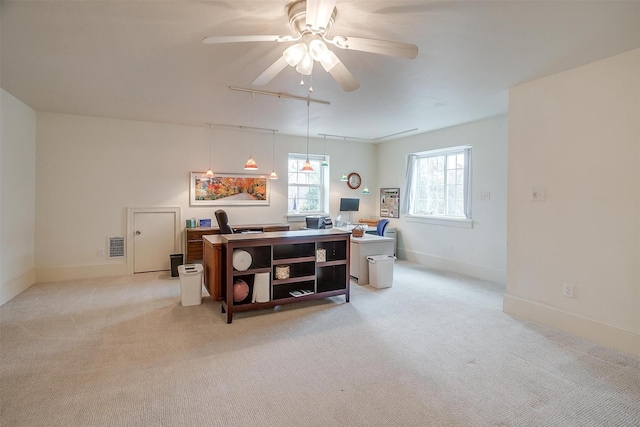 office featuring light carpet, ceiling fan, visible vents, and baseboards