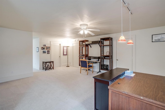 office space featuring track lighting and light colored carpet