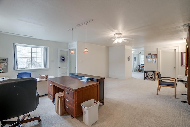 office space featuring light carpet, visible vents, a ceiling fan, and track lighting