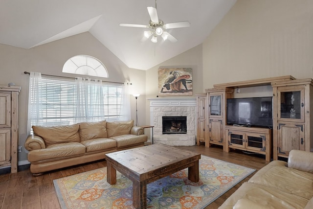 living room featuring dark hardwood / wood-style flooring, a fireplace, high vaulted ceiling, and ceiling fan