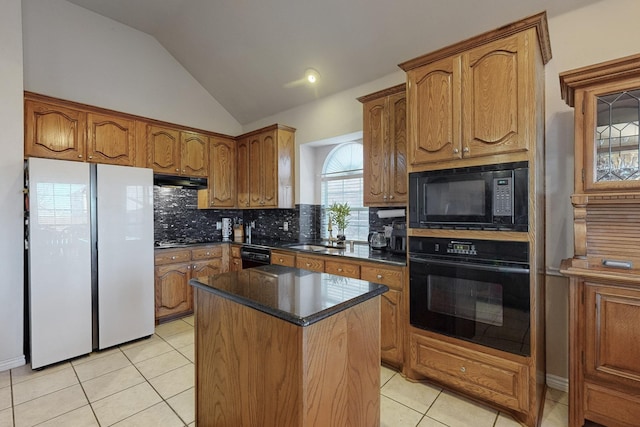 kitchen featuring light tile patterned flooring, a kitchen island, lofted ceiling, decorative backsplash, and black appliances