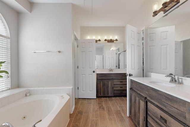 bathroom with a bathing tub and vanity