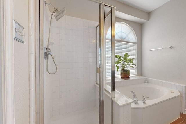 bathroom featuring independent shower and bath