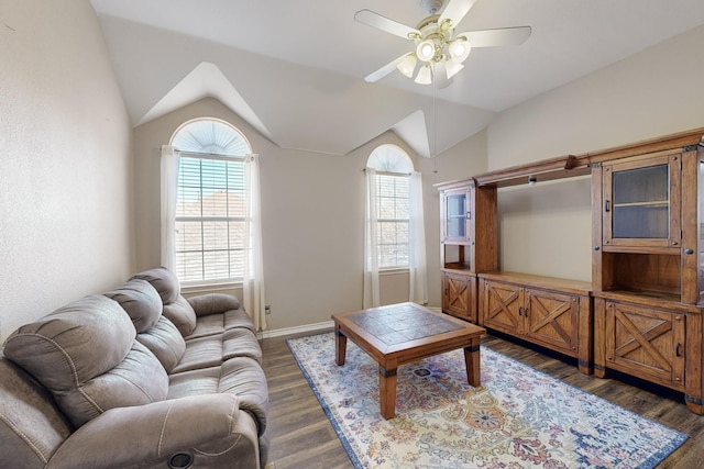 living room with dark hardwood / wood-style flooring, vaulted ceiling, and ceiling fan