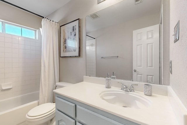 full bathroom with shower / tub combo with curtain, vanity, and toilet