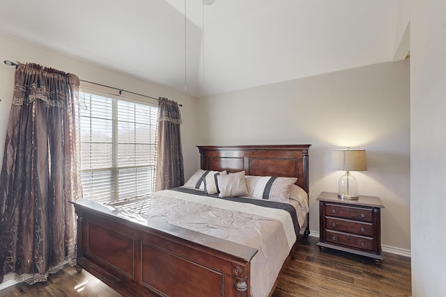 bedroom featuring dark hardwood / wood-style floors and vaulted ceiling