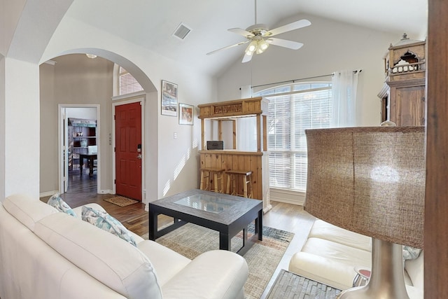 living room featuring ceiling fan, high vaulted ceiling, and light wood-type flooring