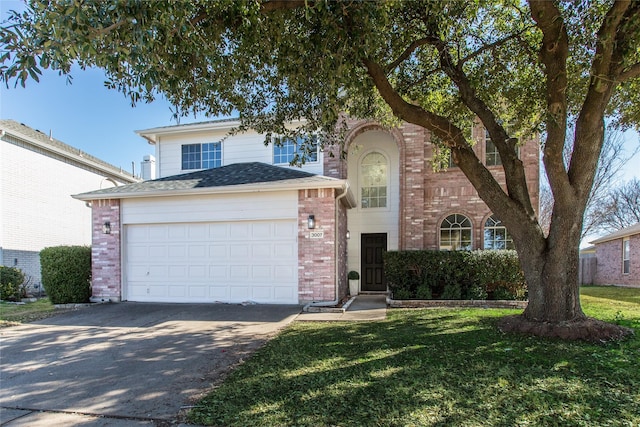 view of front of home with a garage and a front lawn