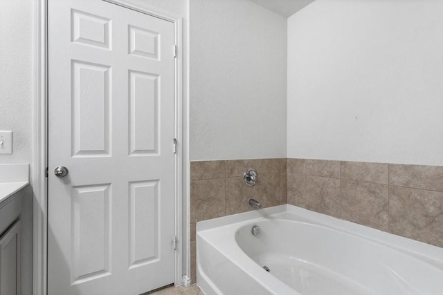 bathroom with vanity and a tub