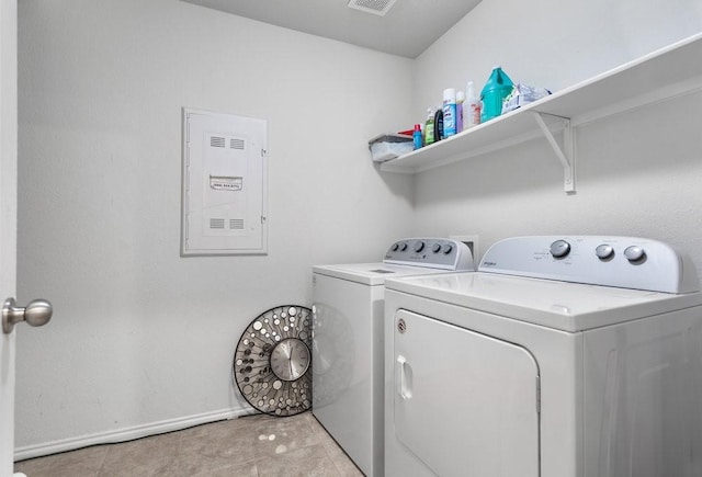 washroom with washing machine and dryer and light tile patterned floors