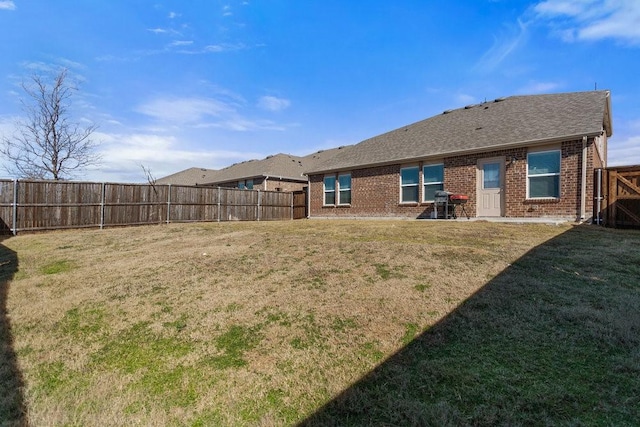 rear view of house featuring a lawn