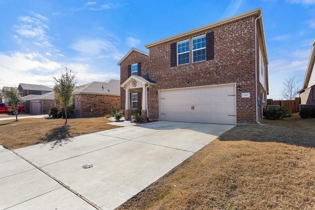 view of property with a garage and a front lawn