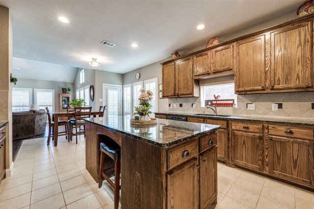 dining room with lofted ceiling, light tile patterned floors, and ceiling fan