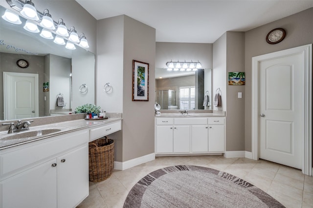 full bathroom featuring two vanities, tile patterned flooring, and a sink