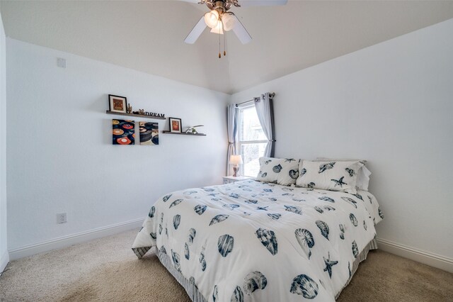 bedroom with vaulted ceiling, light colored carpet, and ceiling fan