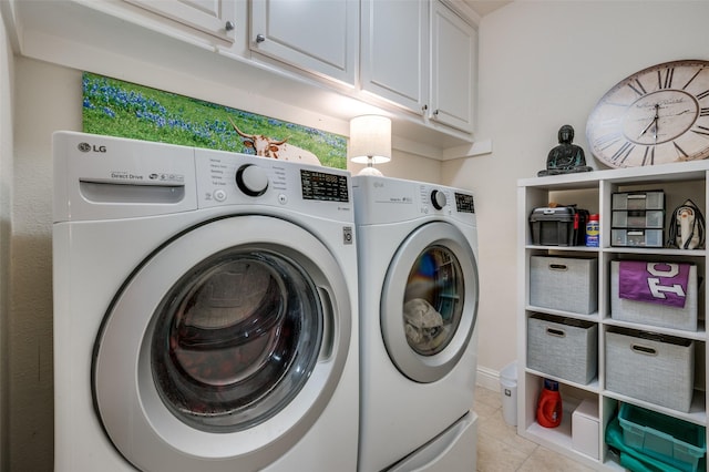 laundry area with separate washer and dryer, light tile patterned flooring, and cabinet space