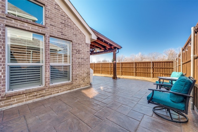 view of patio featuring fence