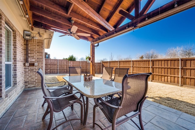 view of patio / terrace with outdoor dining space, a fenced backyard, and ceiling fan