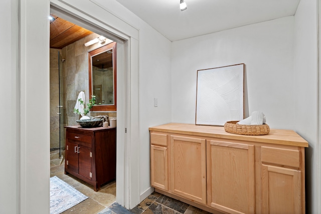 bathroom featuring vanity and a tile shower