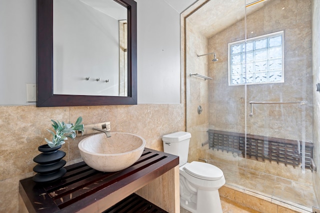 bathroom featuring vanity, tile walls, an enclosed shower, and toilet