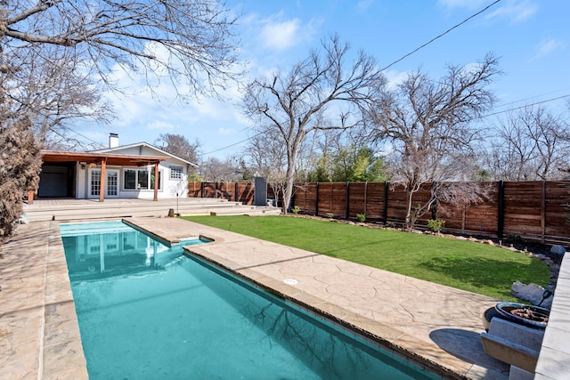 view of swimming pool featuring a patio area, an outdoor structure, and a lawn