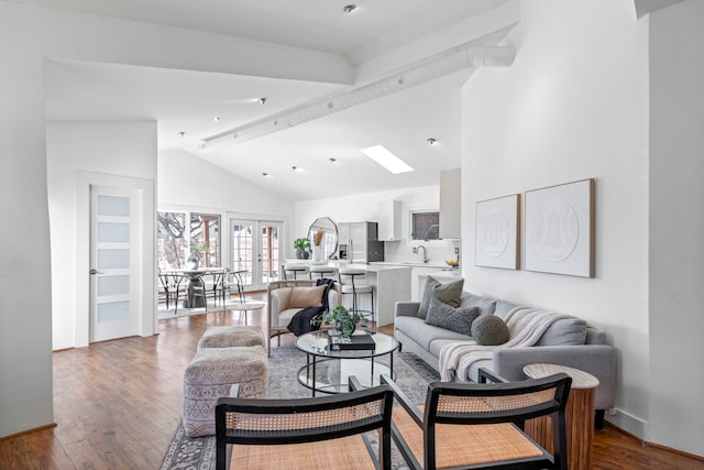 living room with wood-type flooring, sink, high vaulted ceiling, and french doors