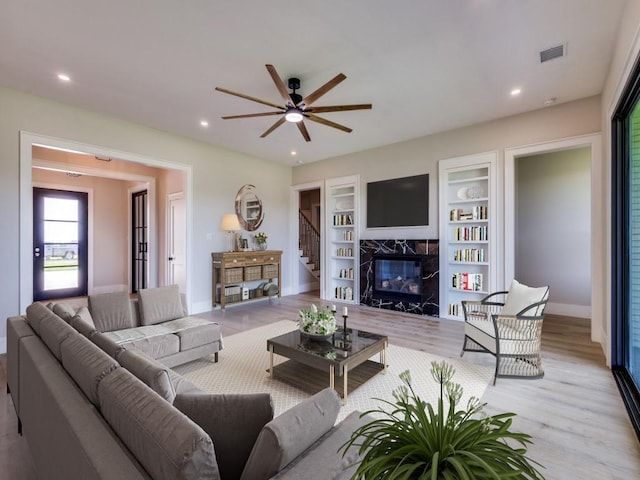 1165 Stonebridge Pass, Gunter, TX 75058 - living area featuring light wood-style floors, a high end fireplace, a ceiling fan, baseboards, and recessed lighting