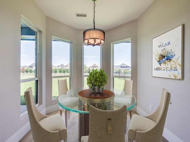1165 Stonebridge Pass, Gunter, TX 75058 - dining space featuring a chandelier, baseboards, plenty of natural light, and wood finished floors