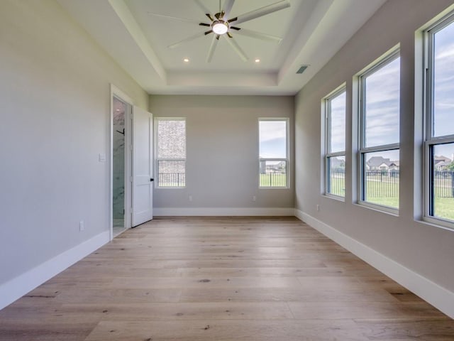 1165 Stonebridge Pass, Gunter, TX 75058 - empty room featuring healthy amount of natural light, a tray ceiling, light wood-style flooring, ceiling fan, and recessed lighting