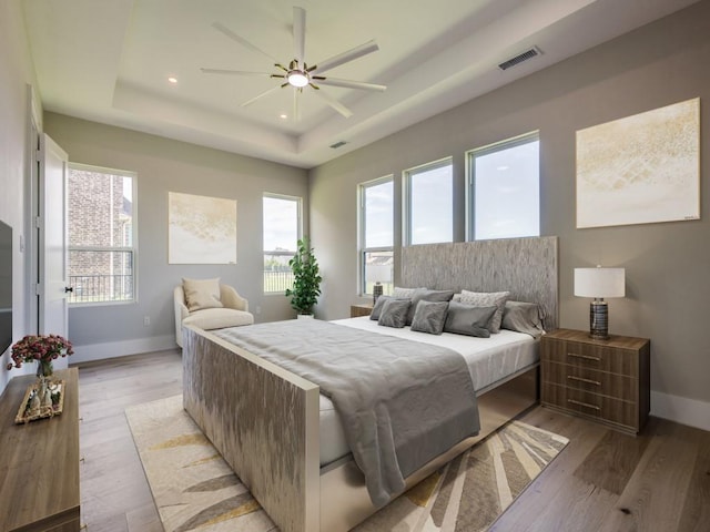 1165 Stonebridge Pass, Gunter, TX 75058 - bedroom with a tray ceiling, baseboards, light wood-type flooring, recessed lighting, and ceiling fan