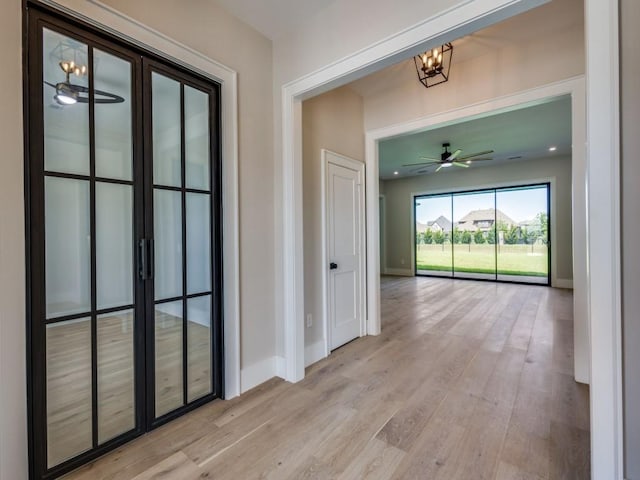 1165 Stonebridge Pass, Gunter, TX 75058 - hallway featuring light wood-style floors, baseboards, and a chandelier