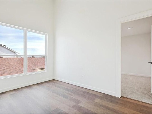 unfurnished room with light hardwood / wood-style floors