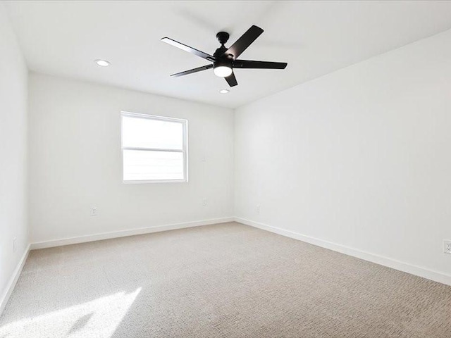 carpeted empty room featuring ceiling fan