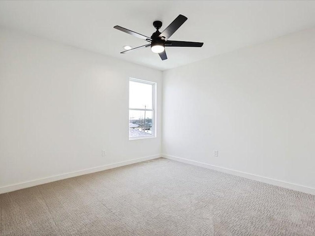 empty room with ceiling fan and carpet