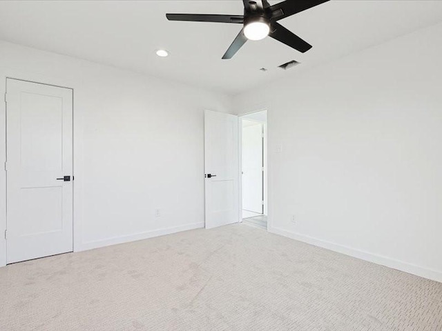 carpeted spare room with ceiling fan