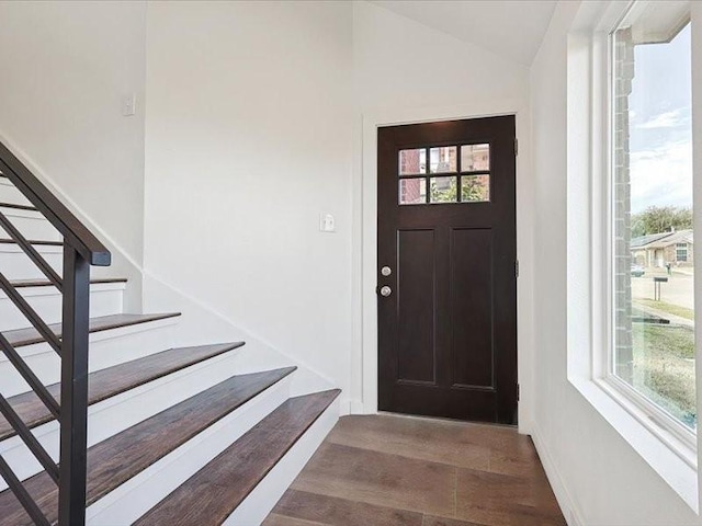 foyer entrance with lofted ceiling and dark hardwood / wood-style floors