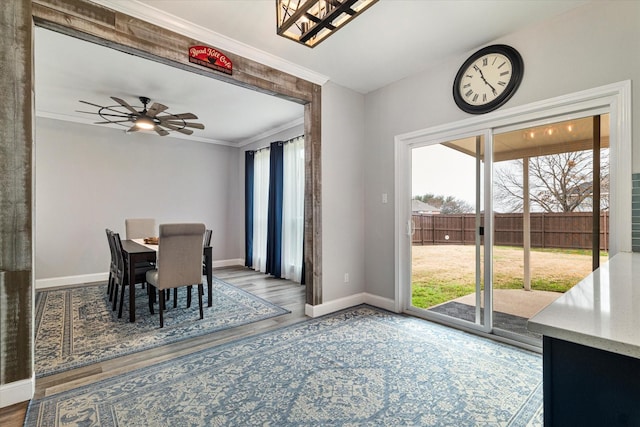 dining area featuring wood-type flooring, ornamental molding, and ceiling fan