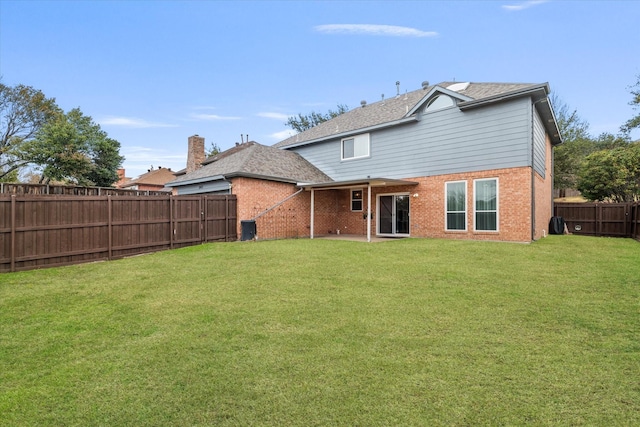 back of house with a lawn